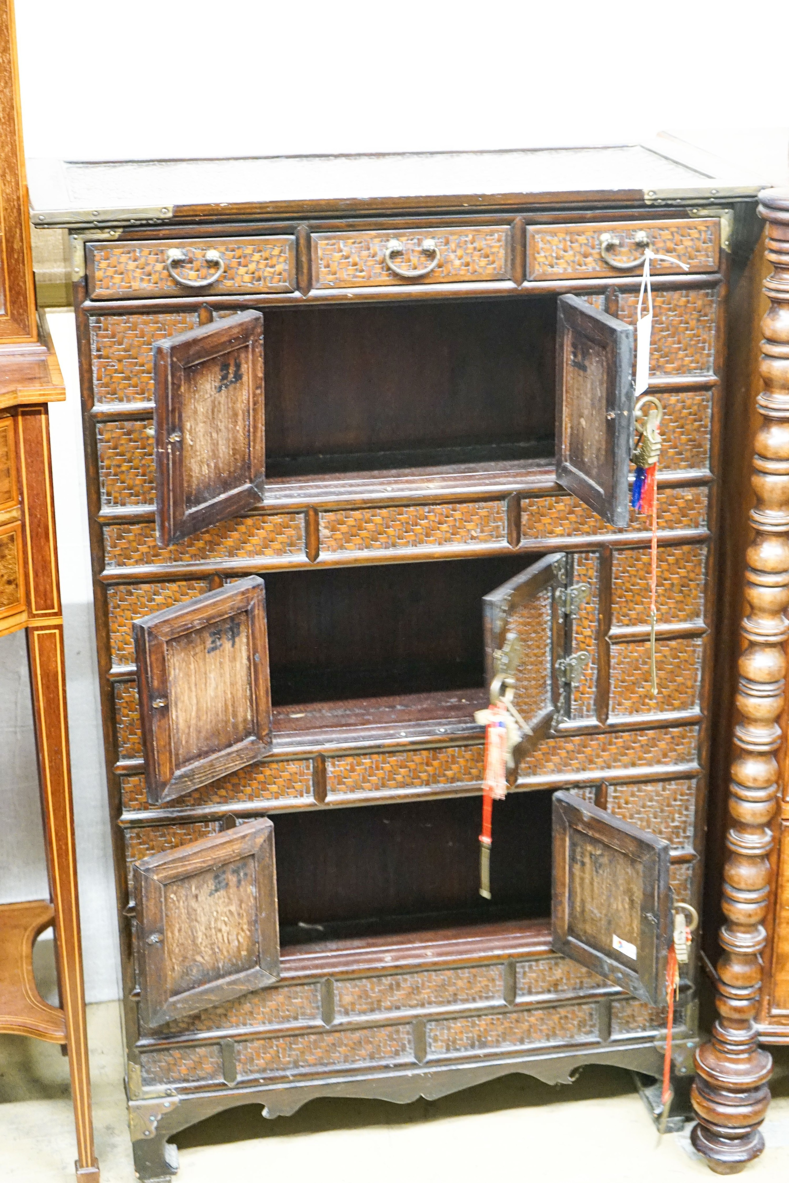 A 20th century Chinese stained wood and rattan side cabinet, width 67cm, depth 32cm, height 104cm